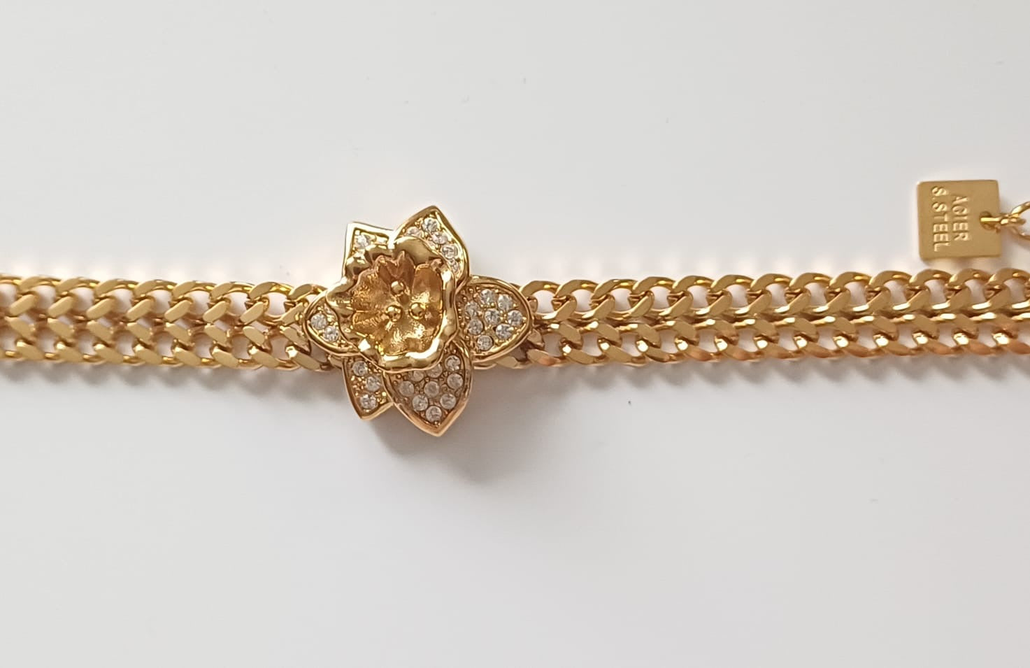 Gourmette américana fleur en acier inoxydable